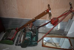 A vintage petrol lawnmower and a push mower