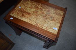A vintage teak and tile top nest of three tables