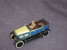An early 20th century Burnett Ltd, London clockwork and tinplate Touring Car with Chauffer having