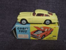 A Corgi diecast, 218 Aston Martin DB4 having opening bonnet in yellow with red interior, in original