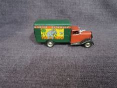 A Triang Minic clockwork and tin plate Carter Paterson Van having green body and red cab