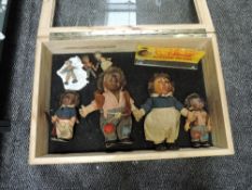 A wooden and glazed display case containing vintage Dolls and Bears including a family of four
