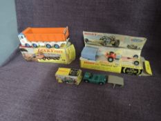 Three Dinky playworn diecasts, 925 Leyland Dump Truck with Tilt Cab having orange body, white & blue
