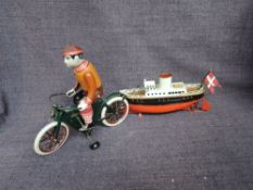 A German tinplate and clockwork model Steam Boat in red, black and white having Danish Flag along