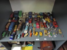 A shelf of playworn diecasts including Dinky 221 Corvette Stingray on card stand, Corgi Whizz Wheels