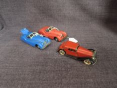 Three Triang Minic clockwork and tin plate Cars, Jaguar XK120 in red, Jaguar XK120 in blue and a