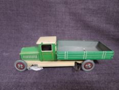 A 1930's Wells clockwork and tinplate Tipping Wagon in green and cream