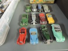 Twelve Dinky playworn diecast Spots and Open Topped Cars including Armstrong Siddeley, Lagonda,