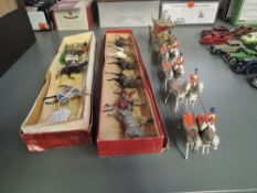 A Britains lead Stage Coach with 8 horses and 4 raiders along with a Britains lead Skinners 6
