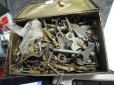 A tin box of Triang, Arnold, Meccano and similar clockwork keys, also includes clock keys