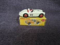 A Dinky diecast, 109 Austin Healey 100 Sports in white with red interior and driver present, in