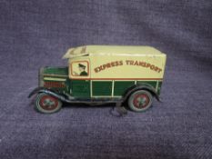 A 1930's Well Toys tinplate and clockwork Express Transport Van in green and yellow, number plate