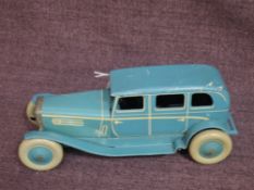 A 1930's Chad Valley clockwork and tinplate saloon car in light blue with cream trim, no key