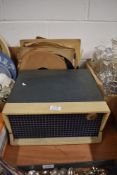 An early 20th century Emerson portable vinyl record player in a green case, with a selection of