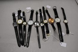 Ten girls/ ladies watches, having black straps.