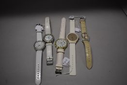 Five white strapped watches