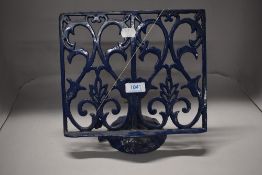 A modern cast metal recipe or book stand
