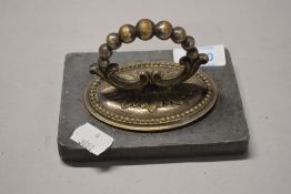 A paper weight made from lead with an entree dish handle