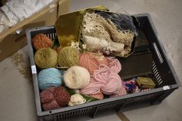 A collection of handicraft materials including knitting wool and embroidery cottons and two