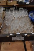A large quantity of cut glass drinking glasses of assorted sizes.