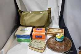 A canvas bag containing an assortment of vintage fishing tackle including hooks weights and line and