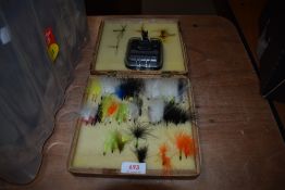 A wooden box of salmon flies and a small unused clip on fly box by wychwood