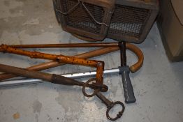 A mixed box of walking sticks a bull stick and racquets