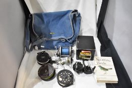 Two canvas bags containing a selection of vintage fishing tackle including fly reels, spinning reels
