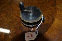 A Small crank wind brass fly reel marked Hardy's Alnwick