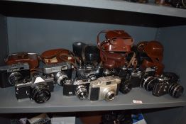 A selection of nine SLR cameras. A Cosina CSR with Cosinoin F1,7 f=50mm lens, a Cosmic 35, a