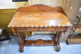 A pitch pine dressing or sewing table having scalloped top with under draw and turned supports.