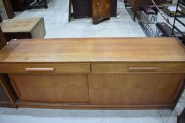 A vintage teak Long John style sideboard having two frieze drawers and sliding doors, width