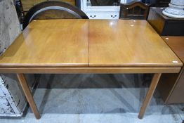 A vintage teak extending dining table of rectangular form