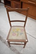 An Edwardian bedroom chair, having replacement needlework seat