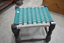 A traditional turned wood frame footstool