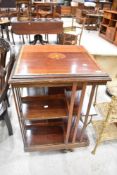 An Edwardian mahogany revolving bookcase having typical inlay decoration, some splitting to top