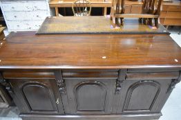 A reproduction mahogany sideboard, the moulded rectangular top above three cushion moulded drawers