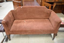 A late Victorian/Edwardian settee having later dralon upholstery and square tapered legs