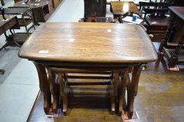 A nest of three Ercol elm occasional tables, the largest with applied Ercol label 42cm x 55cm