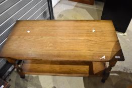 A modern oak coffee table having undesrhelf