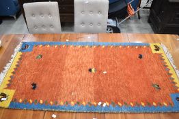 A traditional wool rug, having vibrant avian design, approx 140 x 70cm