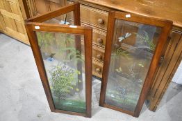 A set of three hinged mahogany glass panels having hand painted decoration of naturalistic design