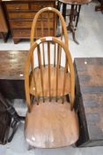 A pair of Ercol high hoop and stick back dining chairs
