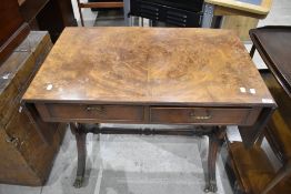 A reproduction side table having double frieze drawers, drop flaps and lyre ends