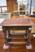 A small dark oak occasional table, having nulled decoration and turned supports, in the manner of