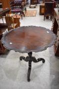A Victorian mahogany occasional table having shaped snap top, turned column and triple splay legs