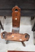 A 20th century birthing stool in Pine on tripod base