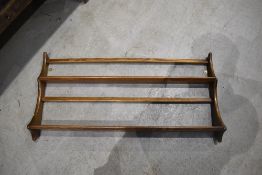 A mid/dark stained Ercol wall shelf, width approx. 96cm