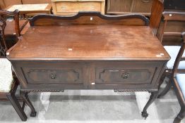 An early 20th century mahogany two-drawer sideboard, with shaped and raised back, moulded and