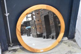 A modern circular pine mirror